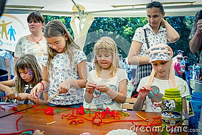 Small girls participating at art and craft outdoor workshop Editorial Stock Photo